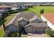 Aerial view of a well-manicured two-story home with stone facade and three car garage at 16736 Broadwater Ave, Winter Garden, FL 34787