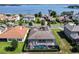Aerial view of the screened-in pool and patio, with a backdrop of the lake and surrounding neighborhood at 16736 Broadwater Ave, Winter Garden, FL 34787