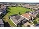 Aerial showcases the property, nearby homes, and lush green landscape, with a picturesque lake in the distance at 16736 Broadwater Ave, Winter Garden, FL 34787
