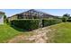 Backyard with a screened-in pool area and privacy hedges, providing a private outdoor retreat at 16736 Broadwater Ave, Winter Garden, FL 34787