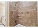 Close-up of the tiled shower showcasing the shower head and glass shelf, next to vanity area at 16736 Broadwater Ave, Winter Garden, FL 34787