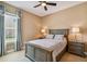 Bright bedroom featuring neutral tones, a ceiling fan, and matching nightstands at 16736 Broadwater Ave, Winter Garden, FL 34787