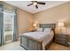 This cozy bedroom has a ceiling fan and two nightstands with lamps at 16736 Broadwater Ave, Winter Garden, FL 34787