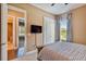 Bedroom featuring a tv, double door closet, and an ensuite bathroom at 16736 Broadwater Ave, Winter Garden, FL 34787