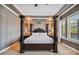 Elegant bedroom features a tray ceiling, decorative columns, and neutral carpeting at 16736 Broadwater Ave, Winter Garden, FL 34787