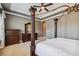 Elegant bedroom features a tray ceiling, decorative columns, and neutral carpeting at 16736 Broadwater Ave, Winter Garden, FL 34787