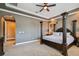 Elegant bedroom features a tray ceiling, decorative columns, and neutral carpeting at 16736 Broadwater Ave, Winter Garden, FL 34787
