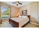 Comfortable bedroom with a ceiling fan and natural light from the window at 16736 Broadwater Ave, Winter Garden, FL 34787