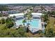 Aerial view of the community pool with palm trees, clear blue water, and plenty of lounge chairs at 16736 Broadwater Ave, Winter Garden, FL 34787