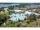 An aerial shot of a resort-style pool with palm trees and modern lounge seating in a Primary planned community at 16736 Broadwater Ave, Winter Garden, FL 34787