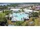 Aerial view of the community pool, featuring a modern design with palm trees and ample seating at 16736 Broadwater Ave, Winter Garden, FL 34787