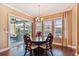 Bright dining room with wood floors, stylish chandelier, and a sliding glass door to lanai at 16736 Broadwater Ave, Winter Garden, FL 34787