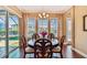 Bright dining room with wood floors, stylish chandelier, and a sliding glass door to lanai at 16736 Broadwater Ave, Winter Garden, FL 34787