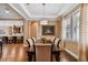 Bright dining room showcases hardwood floors, tray ceilings, modern lighting, and connects to the kitchen at 16736 Broadwater Ave, Winter Garden, FL 34787