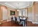 Charming dining room featuring hardwood floors, decorative molding, and a stylish chandelier at 16736 Broadwater Ave, Winter Garden, FL 34787