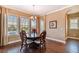 Dining area with large windows providing natural light and views of the backyard at 16736 Broadwater Ave, Winter Garden, FL 34787