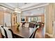 Open-concept dining room with dark wood table and chairs, overlooking the living room area at 16736 Broadwater Ave, Winter Garden, FL 34787