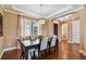 Elegant dining room featuring a wood table, neutral-toned chairs, and windows with light-filtering shades at 16736 Broadwater Ave, Winter Garden, FL 34787