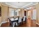 Elegant dining room features hardwood floors, tray ceilings, modern light fixture, and a large window at 16736 Broadwater Ave, Winter Garden, FL 34787