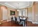 Traditional dining room with hardwood floors, coffered ceiling, and a large window with natural light at 16736 Broadwater Ave, Winter Garden, FL 34787