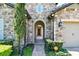 Close-up of the arched entryway, featuring stone accents and a view of the welcoming front door at 16736 Broadwater Ave, Winter Garden, FL 34787