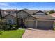 A well-manicured two-story home with stone facade, three car garage, and paver driveway at 16736 Broadwater Ave, Winter Garden, FL 34787