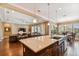 Open kitchen featuring a large island with seating, views into the living and dining areas, and hardwood floors at 16736 Broadwater Ave, Winter Garden, FL 34787