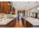 Well-equipped kitchen featuring an island, modern appliances, and hardwood floors leading to the dining area at 16736 Broadwater Ave, Winter Garden, FL 34787