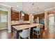 Gourmet kitchen with a large center island, stainless steel appliances, tile backsplash, and wood cabinets at 16736 Broadwater Ave, Winter Garden, FL 34787