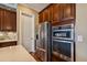 Kitchen includes modern stainless steel refrigerator and a built in oven and microwave at 16736 Broadwater Ave, Winter Garden, FL 34787