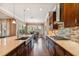 Bright kitchen with a gas cooktop, large island with sink, hardwood floors, and connects to the dining area at 16736 Broadwater Ave, Winter Garden, FL 34787