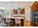 Eat-in kitchen with granite countertops, stainless steel appliances, modern tile backsplash, and wood cabinets at 16736 Broadwater Ave, Winter Garden, FL 34787