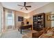 Office space featuring a large desk, bookcase, a large window, and a comfortable sofa at 16736 Broadwater Ave, Winter Garden, FL 34787