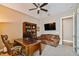 This office has a large bookcase, sofa, TV, and a traditional wooden desk and chair at 16736 Broadwater Ave, Winter Garden, FL 34787