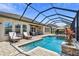 Backyard pool with a screened-in lanai and lounge chairs, perfect for relaxing and enjoying the outdoors at 16736 Broadwater Ave, Winter Garden, FL 34787