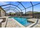 Screened pool area with water feature and lounge chairs, designed for backyard relaxation and entertaining at 16736 Broadwater Ave, Winter Garden, FL 34787