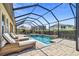 Screened-in pool area with lounge chairs and a dining table, ideal for outdoor relaxation and entertainment at 16736 Broadwater Ave, Winter Garden, FL 34787