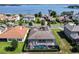 Stunning aerial view of a screened-in pool with lake views, surrounded by well-manicured landscaping and tile roof at 16736 Broadwater Ave, Winter Garden, FL 34787