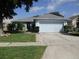 Charming single-story home featuring a well-maintained lawn and a two-car garage in a peaceful neighborhood at 2014 Corner Meadow Cir, Orlando, FL 32820