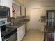Well-lit kitchen featuring stainless steel appliances, granite countertops, and white cabinets at 2014 Corner Meadow Cir, Orlando, FL 32820