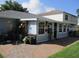 Enclosed sunroom with lots of windows offering natural light with access to a brick patio in backyard at 2014 Corner Meadow Cir, Orlando, FL 32820