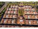 Aerial shot of a planned residential community showcasing townhomes with terra cotta roofs, landscaping, and organized layout at 204 David Walker Dr # A-4, Tavares, FL 32778