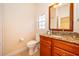 Well-lit bathroom featuring a granite countertop vanity and tile floors at 204 David Walker Dr # A-4, Tavares, FL 32778