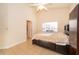 Serene bedroom featuring a vaulted ceiling, neutral walls, a large window, and tiled floors at 204 David Walker Dr # A-4, Tavares, FL 32778