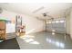 Spacious two car garage with epoxy flooring, storage shelves, and garage door opener at 204 David Walker Dr # A-4, Tavares, FL 32778