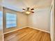 Bedroom featuring wood floors, a ceiling fan and a window with blinds for privacy and light control at 2073 Newtown Rd, Groveland, FL 34736