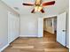 Bedroom with wood floors, a ceiling fan and a doorway to another room at 2073 Newtown Rd, Groveland, FL 34736