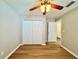 Bright bedroom with wood floors, double closets, ceiling fan and an adjoining room at 2073 Newtown Rd, Groveland, FL 34736