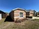 Side view showcasing the house's facade, driveway, and landscaping details at 2073 Newtown Rd, Groveland, FL 34736