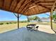 Covered gazebo featuring picnic table and benches with view to neighborhood play area with slide at 2073 Newtown Rd, Groveland, FL 34736